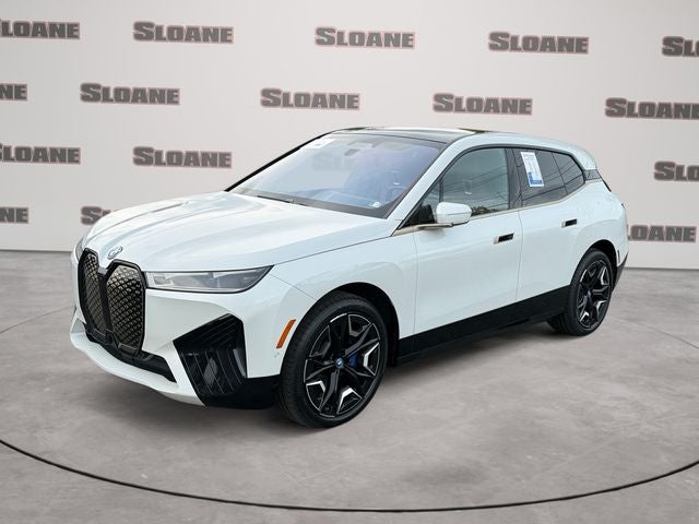 2024 BMW iX xDrive50 in White Metallic — front three-quarter view